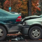Two damaged cars after a rear-end accident, illustrating the aftermath of a collision and potential liability issues.