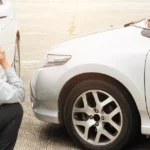 Frustrated driver and adjuster discussing delayed car accident settlement